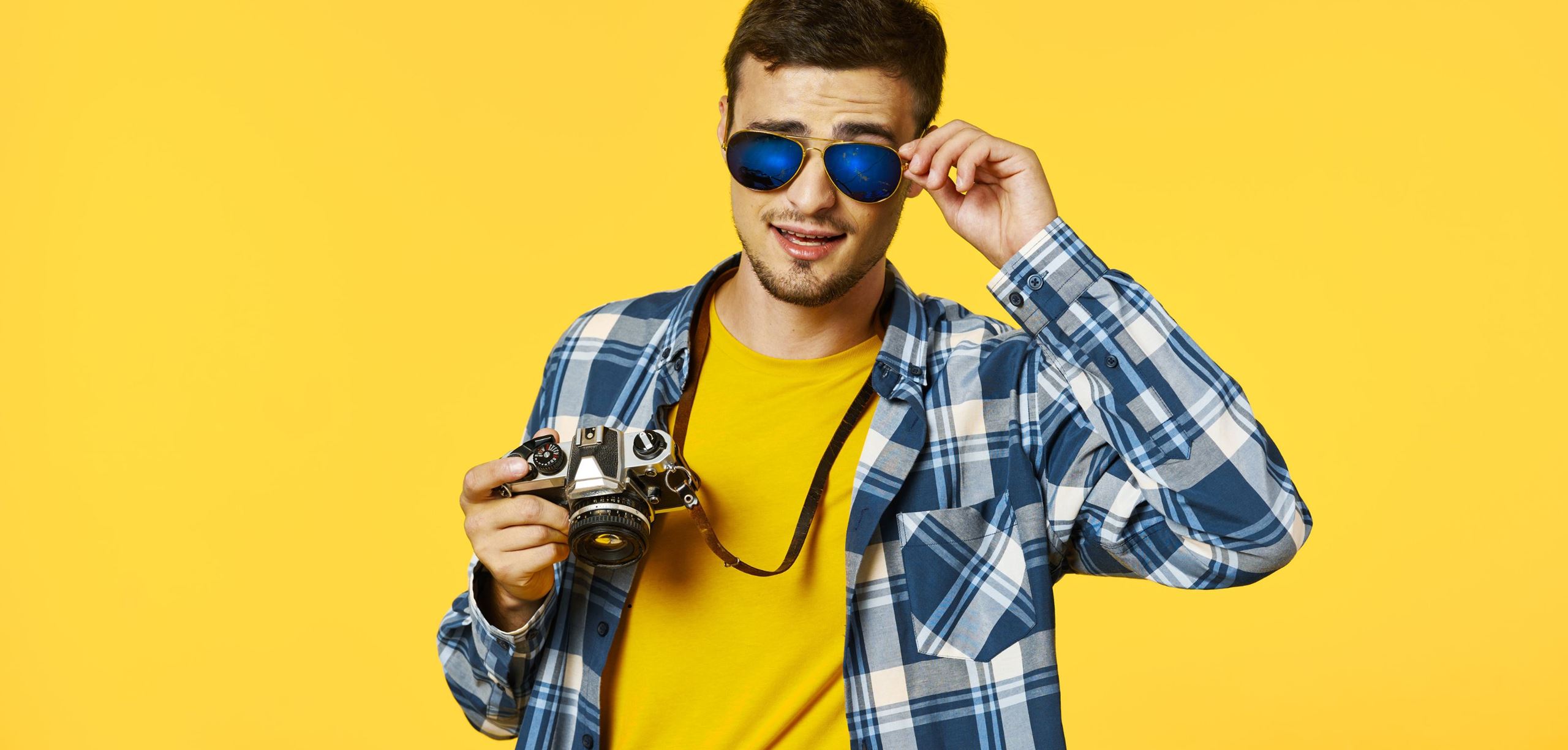 Man wearing sunglasses and holding a camera