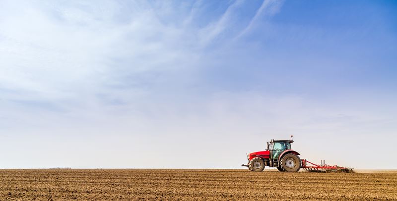 Farmer in tractor preparing land