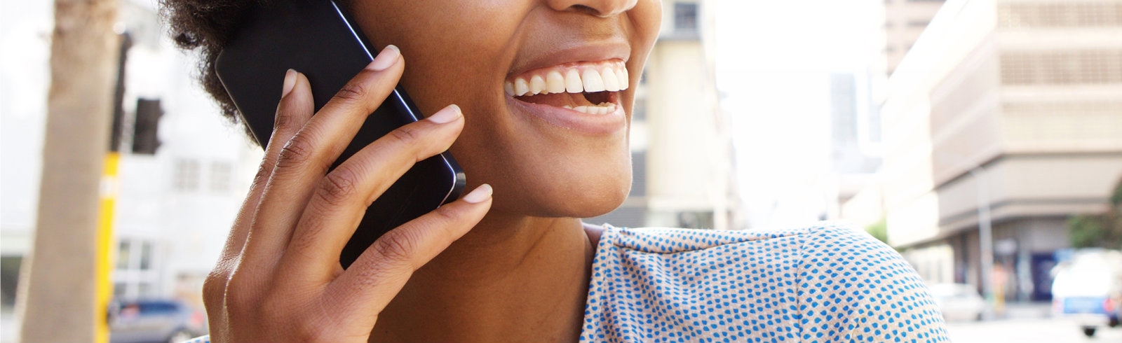 A women smiling while on her phone