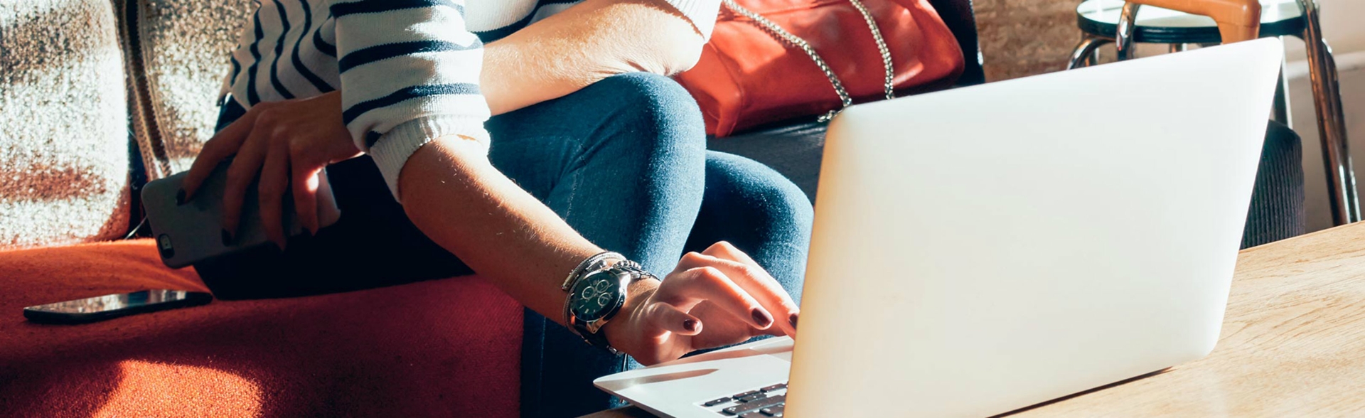 Woman on a coffee table looking at a laptop