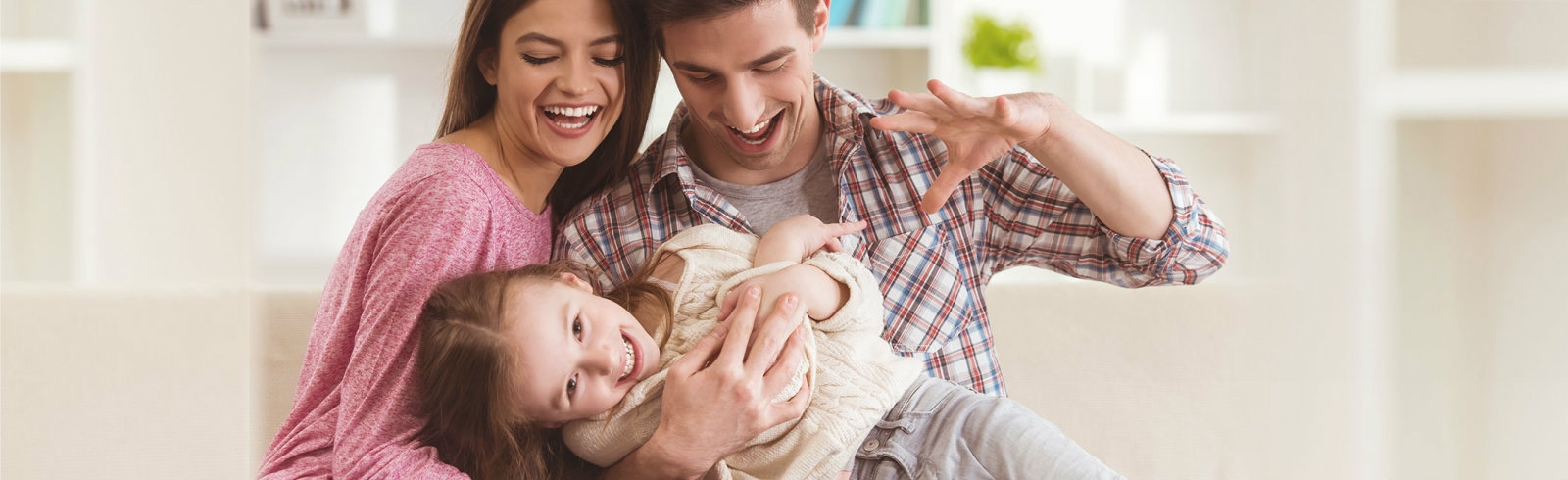 A couple playing with their daughter