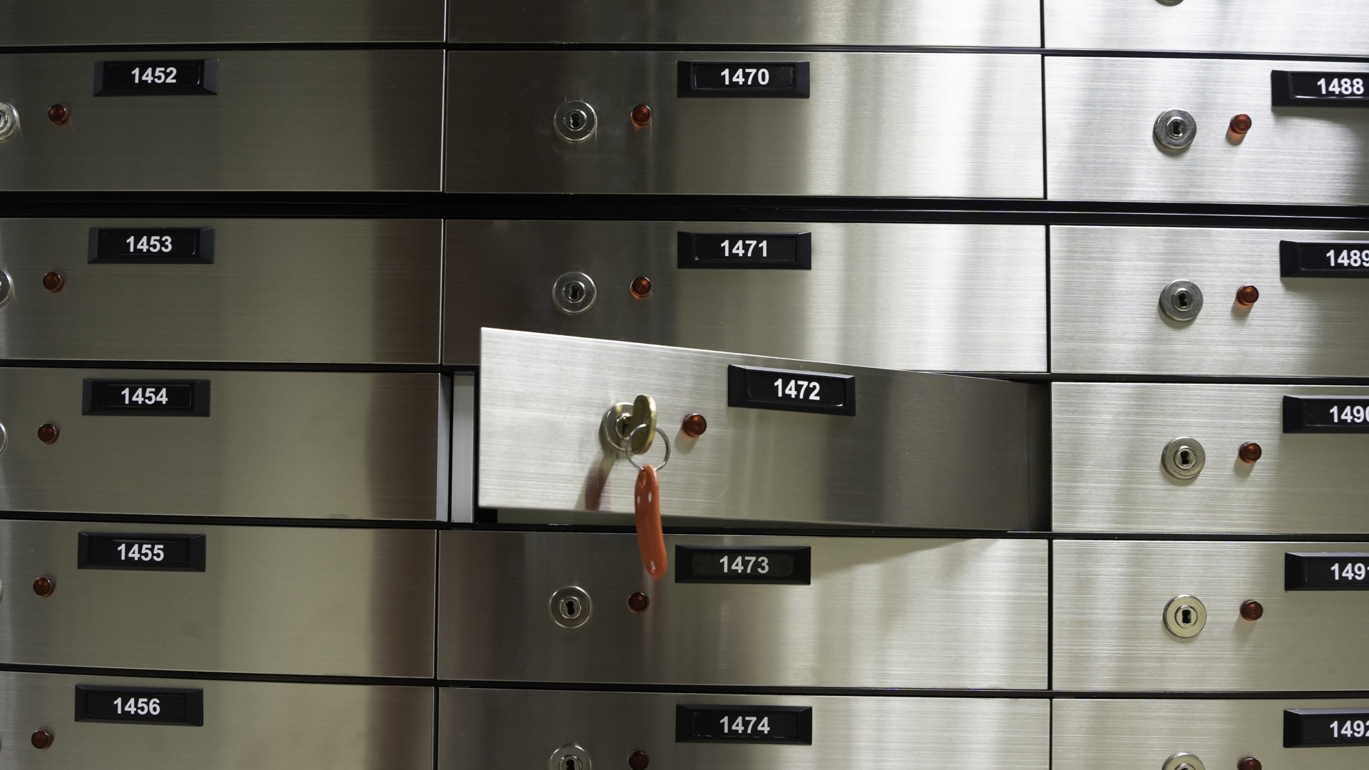 Safe deposit boxes inside bank vault. Open deposit box with key