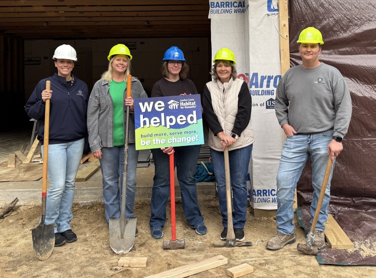 SSB Employees in front of house under construction