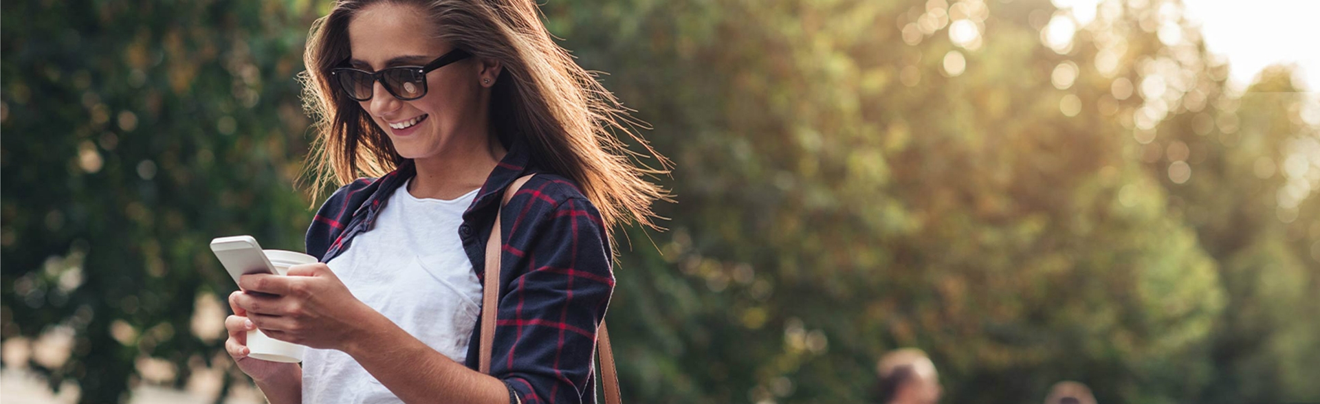 Woman looking at a phone in a park