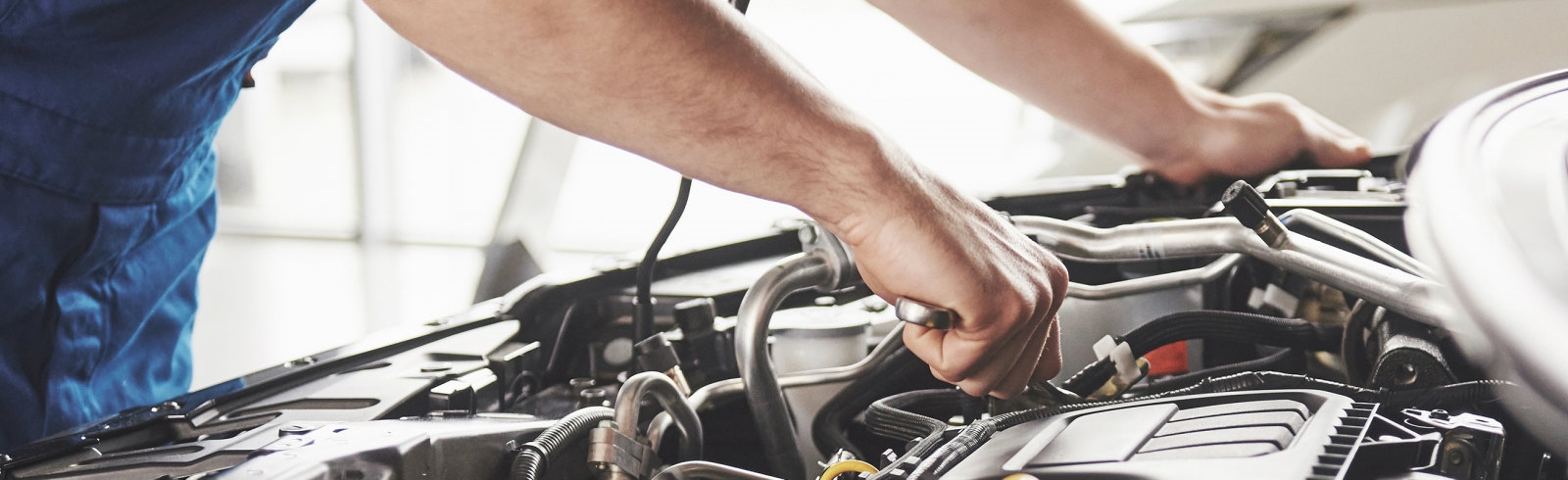 A man inspecting a car engine